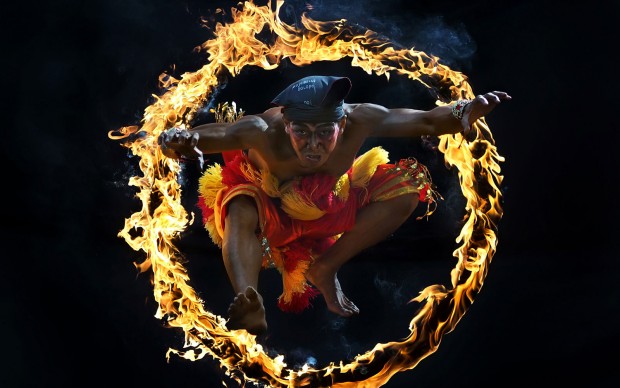 One of traditional attraction in Indonesia Culture called Bujang Ganong. He jumped into the circle of fire.