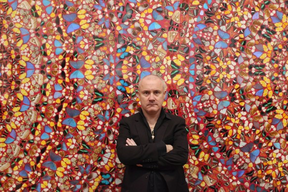 Damien Hirst posa di fronte alla sua opera  I am Become Death, Shatterer of Worlds presso la Tate Modern di Londra all'interno della prima retrospettiva dedicata all'artista, nel 2012. Credits: Oli Scarff/Getty Images