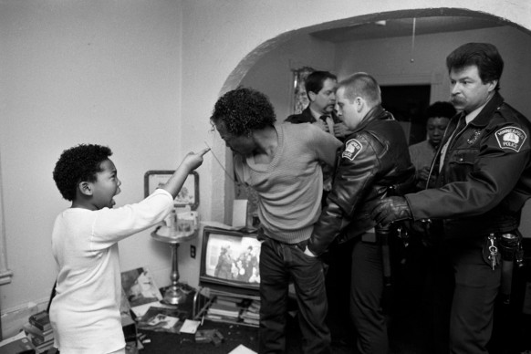As the police arrested his father, Diamond said "I hate you for hitting my mother! Don't you come back to this house!" Minneapolis, MN, 1988 © Credits: Donna Ferrato