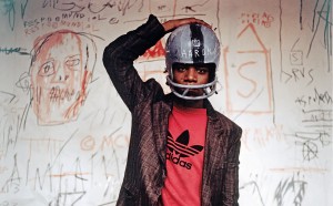 Jean-Michel Basquiat wearing an American football helmet, 1981. Photo: © Edo Bertoglio, courtesy of Maripol. Artwork: © The Estate of Jean-Michel Basquiat. Licensed by Artestar, New York