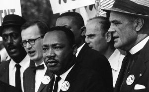 Martin Luther King Jr. e Mathew Ahmann in mezzo alla folla durante la Marcia per i Diritti Civili͟. È in questa occasione che è stato pronunciato da Martin Luther King, davanti al Lincoln Memorial, il suo più famoso discorso dal titolo ͞I have a dream͟. 28 agosto 1963 Washington, D.C., USA Foto di Rowland Scherman (1937) © Courtesy U.S. Information Agency - Press and Publications Service / NARA - National Archives and Records Administration
