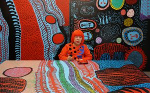 Portrait of Yayoi Kusama in her studio. Image © Yayoi Kusama. Courtesy of David Zwirner, New York; Ota Fine Arts, Tokyo/Singapore/Shanghai; Victoria Miro, London; YAYOI KUSAMA Inc.
