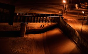 Paolo Pellegrin, Two men who attempted to enter the U.S. illegally run across the dry Rio Grande riverbed back to Ciudad Juárez, Mexico, after being spotted by the U.S. Border Patrol. El Paso, Texas. USA 2011 © PAOLO PELLEGRIN/MAGNUM PHOTOS