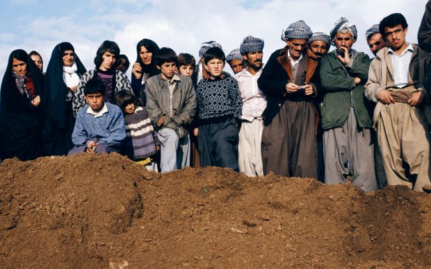 Susan Meiselas, Villagers watch exhumation at a former Iraqi military headquarters outside Sulaymaniyah, Northern Iraq, 1991 © Susan Meiselas, 2018