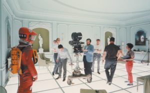 On the Hotel Room set of 2001: A SPACE ODYSSEY (1968, Dir. Stanley Kubrick). Kubrick is shown at center behind the camera. Credit: Courtesy of Warner Bros.