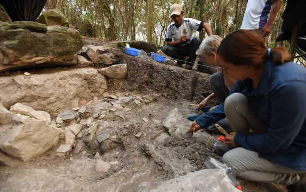 Melina Garcia (right) and Daniela Triadan excavating a ceramic deposit behind the megalithic structure of Aguada Fénix. Credit Takeshi Inomata