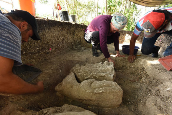 Veronica Vazquez (center) excavating the Middle Preclassic sculpture (1000-700 BC) in the periphery of Aguada Fénix. Credit Takeshi Inomata