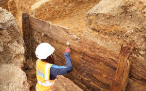 Archaeologists excavating the timber structure. Credit UCL Archaeology South-East