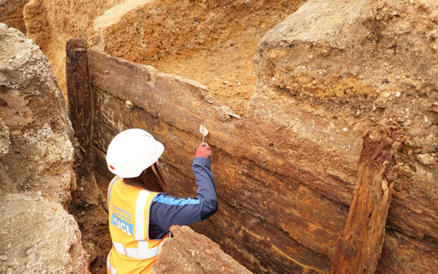Archaeologists excavating the timber structure. Credit UCL Archaeology South-East