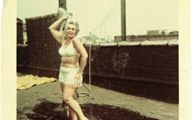 ‘Tootsie’ Viviano cooling off under her homemade shower, 96 Elizabeth Street, 1964