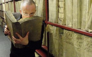 Prof. Matija Strlic smelling a historic book in the National Archives of The Netherlands © Matija Strlic