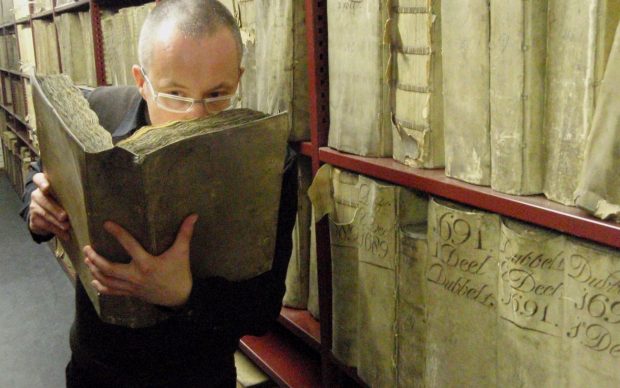 Prof. Matija Strlic smelling a historic book in the National Archives of The Netherlands © Matija Strlic
