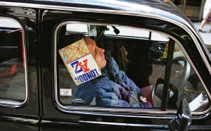 A sleeping taxi driver in Lime Street, City of London, c. 1990