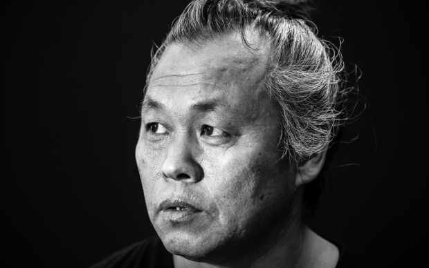 VENICE, ITALY - AUGUST 27: (EDITORS NOTE: Image has been converted to black and white) Director Kim Ki-duk attends a portrait session for his film 'One on One' during the 71st Venice Film Festival on August 27, 2014 in Venice, Italy. (Photo by Franco Origlia/Getty Images)