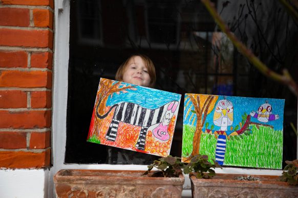 Artwork depicting animals, created by Raymond and Leonard is displayed in the window of a house in Acton, London. Photo David Parry/PA Wire