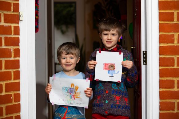 Artwork depicting animals, created by (left to right) Jim, aged 5 and Nora, aged 7 is displayed on a row of houses in Acton, London. Photo David Parry/PA Wire