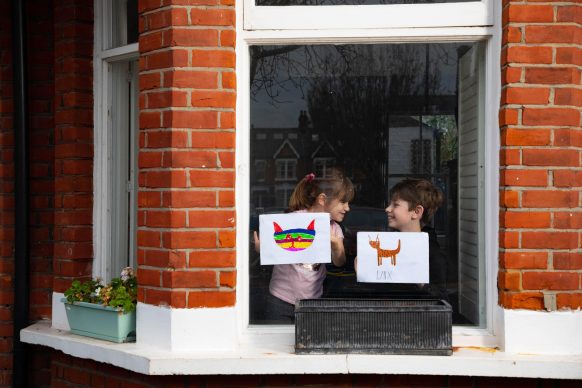 Artwork depicting animals, created by (left to right) Romey and Iggy is displayed in the windows of a row of houses in Acton, London. Photo David Parry/PA Wire