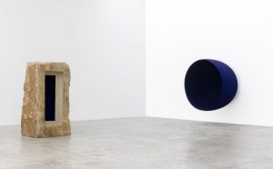 Left: Untitled, 1992. Sandstone and pigment, 230 x 122 x 103 cm. Right: Void, 1989. Fibreglass and pigment, 200 x 200 x 152.5 cm. Photograph: Michel Zabe © Anish Kapoor. All rights reserved DACS, 2021