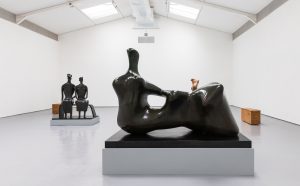 This Living Hand: Edmund de Waal presents Henry Moore, 2021. Installation view with Henry Moore, Reclining Figure: Hand 1979 Bronze (LH 709), King and Queen 1952-53 bronze (LH 350), Mother and Child 1978 Stalactite (LH 754) and Edmund de Waal, tacet XII and XIII, Hornton stone, 2020. Reproduced by permission of the Henry Moore Foundation, Edmund de Waal and New Art Centre, Wiltshire. Photo: Alzbeta Jaresova